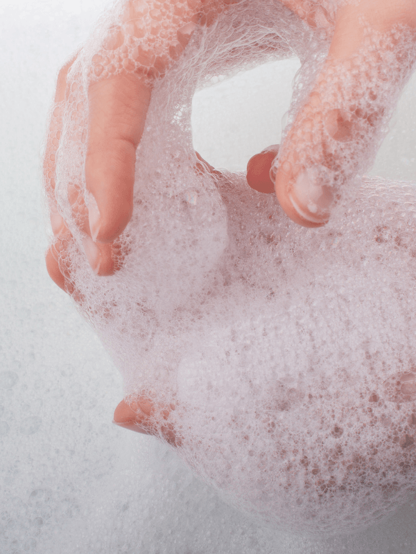 Eclat Soin Hand & Body Wash, Patchouli & Amber Vanilla creating rich bubbles for a soothing experience